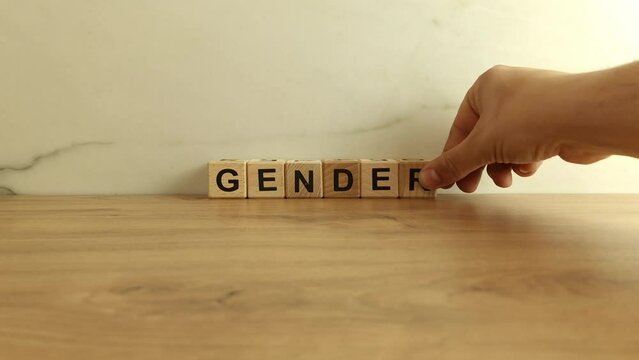 Word gender made of wooden blocks. Equality, discrimination, prejudice concepts
