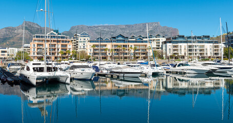 Fototapeta na wymiar Yachts panorama in Cape Town harbour marina with Table Mountain reflection, Cape Town, South Africa.