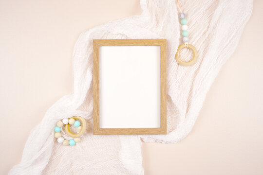 Artwork picture frame product mockup. Baby shower 1st birthday Christening gender neutral party. Styled setting against a boho Scandi theme beige and white background. Negative copy space.