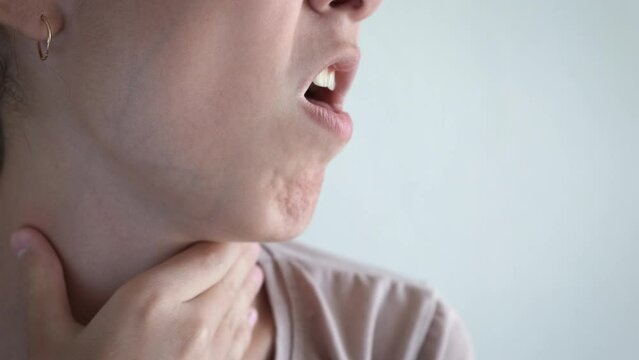 Sore throat. The girl suffers from a sore throat.
