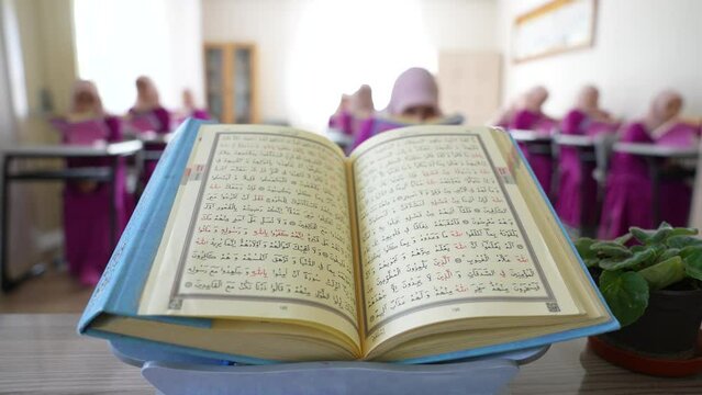 Students studying the Qur'an in a private school