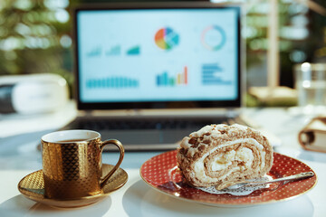 Closeup on table in modern office with piece of cake