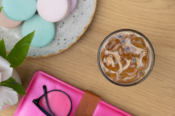 Iced latte coffee in glass on cafe table background top view. Summer fresh coffe drink