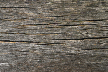 Naklejka premium Old weathered wooden brown board structure with horizontal cracks. Close up natural grunge timber texture background, board floor, backdrop, wallpaper