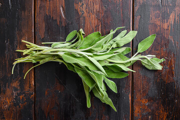 Sage on dark old wooden table top view.