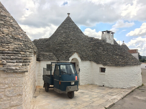 A vehicle in front of truli in Alberobello