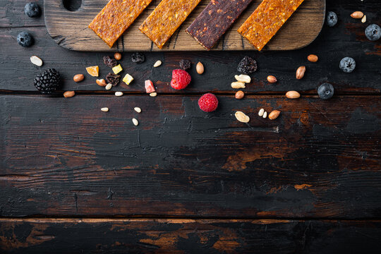 Dried fruits bars, top view with copy space, on wooden table
