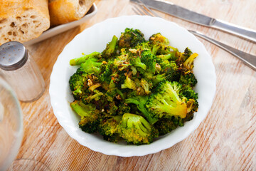 Fried broccoli with spices on a plate. Top view.