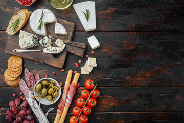 Antipasti platter with fresh cheese, bread and olives, on dark wooden background, top view  with copy space for text