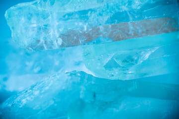 transparent crystals background in blue tones.texture of gemstone.Rock crystal macro texture in blue light. crystals of natural transparent stone rock.Texture of natural stone Rock crystal