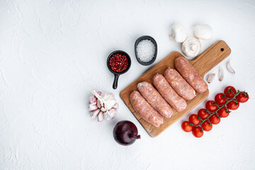 Raw pork sausages with space for text, on white background