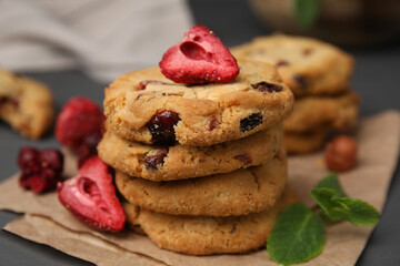 Cookies with freeze dried fruits, mint and nuts on grey table, closeup