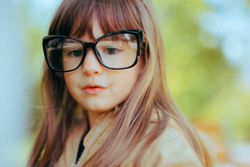 Portrait of a Smart Toddler Wearing Glasses. Little eyeglasses wearer kid thinking of clever things
