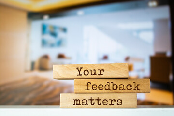 Wooden blocks with words 'Your feedback matters'.