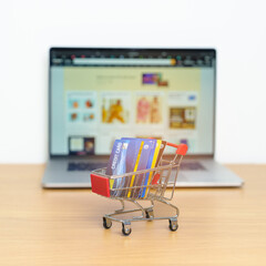 Shopping cart with Credit Cart and laptop computer with marketplace website. Online Shopping,...