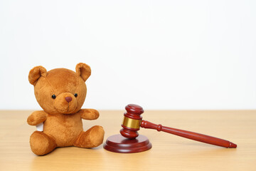 Children, Kid and Family Law concepts. toy bear with gavel justice hammer on desk in courthouse.
