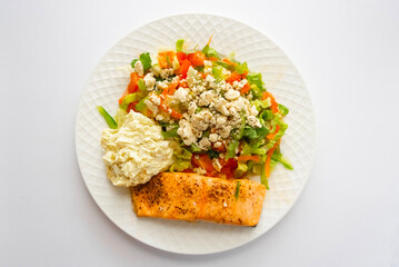 Salmon with salad and american potato salad on white background
