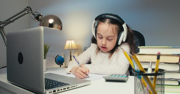 Girl Child Studying in Online Kolas at Home. Back to School, Online Learning, Distance Lesson, Homeschooling, School Technology, Tutored Lessons. Children Doing Homework at Home