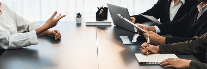 Candidate and interviewers discuss work experience and qualifications in friendly job interview at corporate office. HR team evaluates job application while interviewee explaining profile. Prodigy