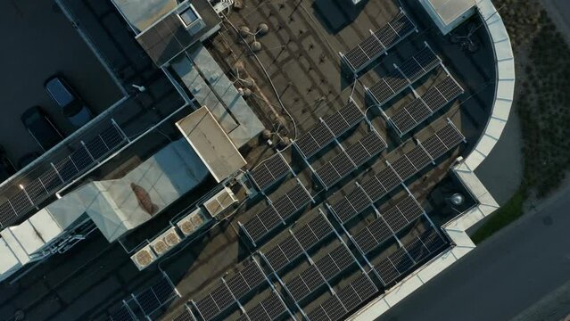 Aerial View Solar Panels on the Roof of an Apartment Building. Green Renewable Energy Theme. Commercial Office Building in the City Center. Reducing the Carbon Footprint.