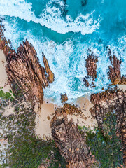 Aerial top down view of beach and clear blue water. Ocean waves on the beach as a background....