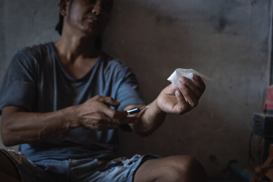A drug addict is happily addicted to heroin, dope concept, World Anti-Drug Day.