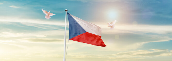 Waving Flag of Czech Republic in Blue Sky. The symbol of the state on wavy cotton fabric.