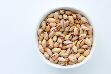  top view of pistachios nut on in bowl on white background 
