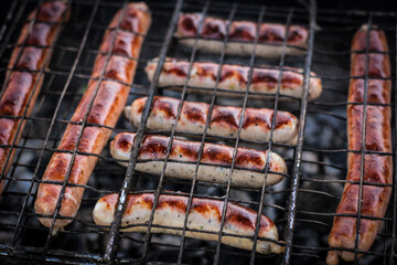 Sausage cooked on the grill outdoors. Grilled food, barbecue.