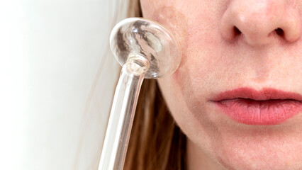 the girl does facial skin care with the darsonval device