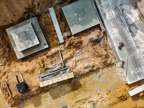 Monolithic reinforced concrete foundations or grillages for the construction of a large modern residential building. Rostverk at the construction site. Foundation for the building. View from above.