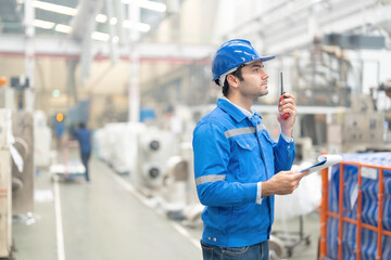 half side photo white american engineer standing in charge and use radio communication holding a...