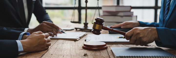Lawyer or judge holding Hammer prepares to judge the case with justice, and litigation, scales of justice, law hammer, Legal consulting services, Concept of litigation, and legal services.