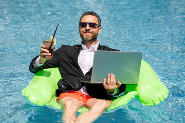 Summer vacations and freedom travel concept. Portrait of funny business man on the beach....