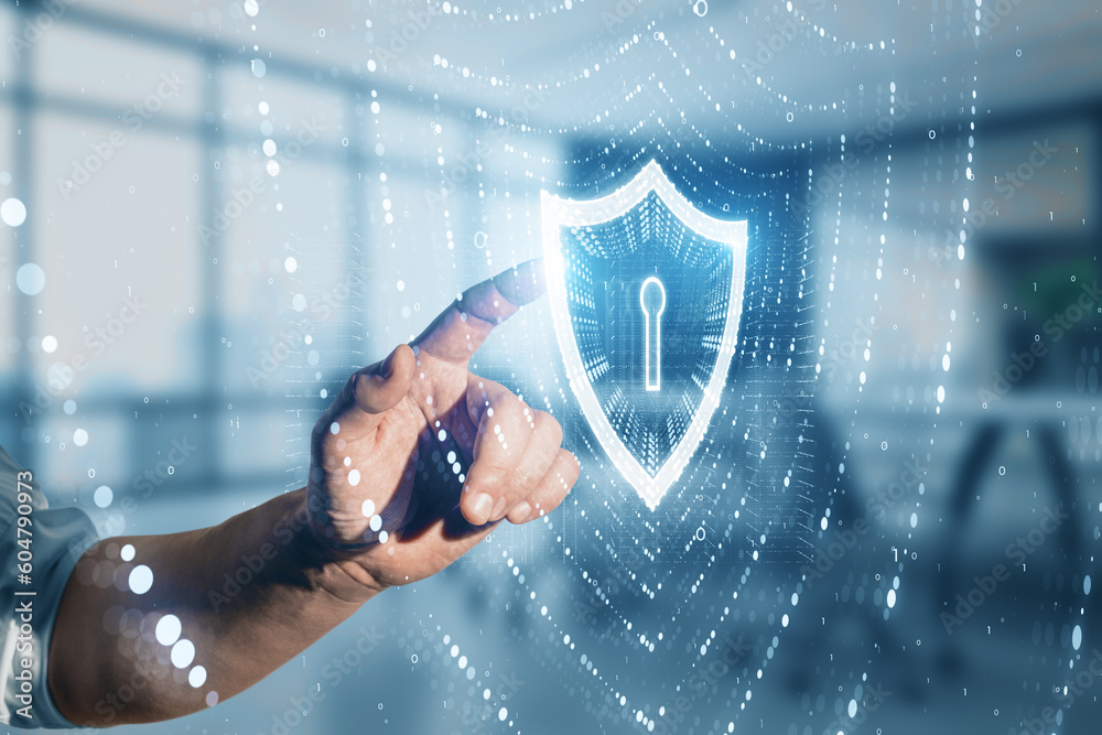Poster close up of businessman hand pointing at glowing polygonal web security shield hologram on blurry of