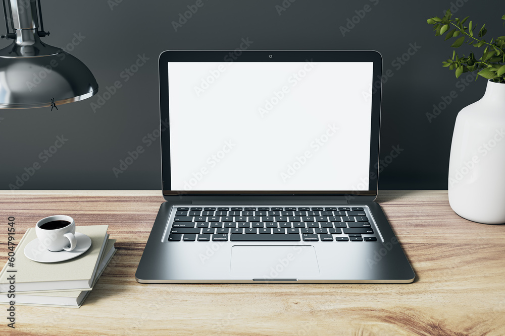 Poster front view on blank white modern silver laptop screen with space for web design or site on wooden ta