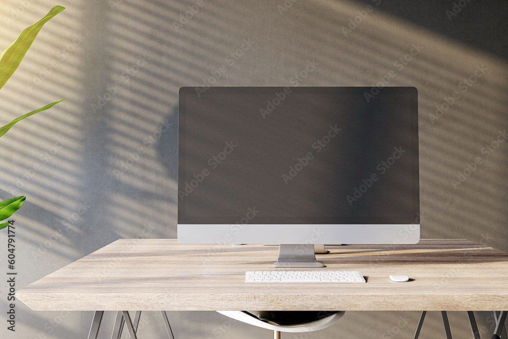 Poster front view of a home workplace with wooden desk with blank screen modern computer on dark wall backg