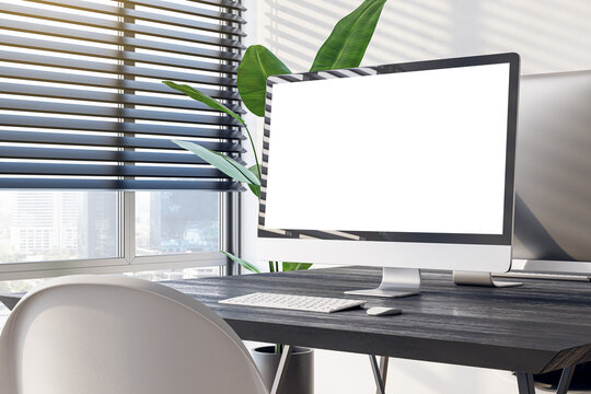 Side view of a modern office workplace with black desk with blank screen computer on big window with city view background in light interior, mockup. Webdesign concept. 3D Rendering