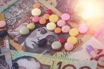 Different dispersed pills on australian dollar banknotes