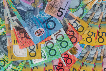 Colorful australian dollars laying on wooden table