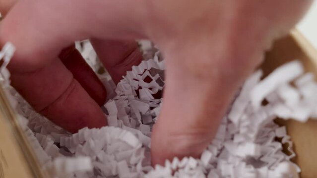 Packing parcel box with white shredded plastic filler close up