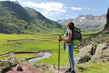 Relaxed hiker breathing fresh air in a mountain valley