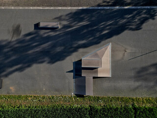 Skateboard park with concrete cement surface with concrete skateboard obstacles is designed for roller sports. Cycling is not allowed except for freestyle bikes.  winter morning sunrise, above, high