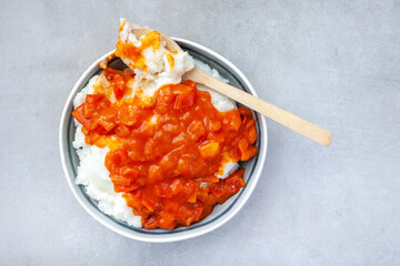 Traditional South African pap or maize meal with traditional sauce of tomato and onion on mottled grey