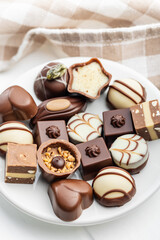 Sweet chocolate pralines.  Tasty chocolate truffles on plate.