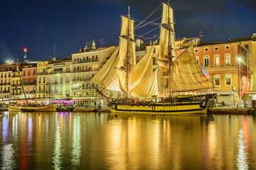 France, Herault, Sete, Sailing ship moored along Canal du Midi at dusk