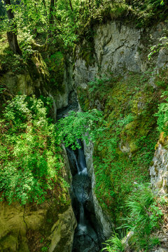 Austria, Tyrol, Waterfall in steep narrow canyon