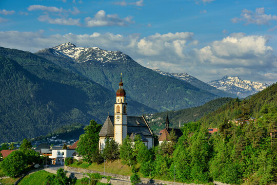 Austria, Tyrol, Tarrenz, Mountain village in summer with church in foreground