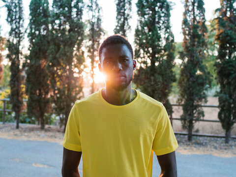 Athlete wearing yellow t-shirt in front of trees