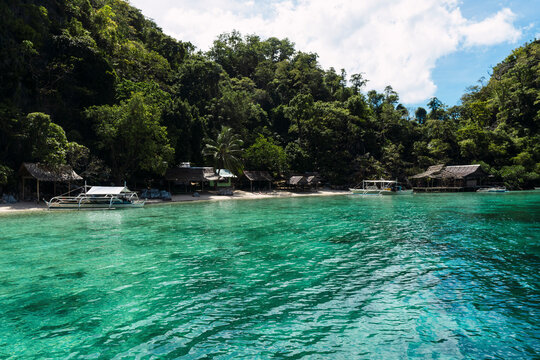 Sea with huts and trees at Coron Island in Philippines